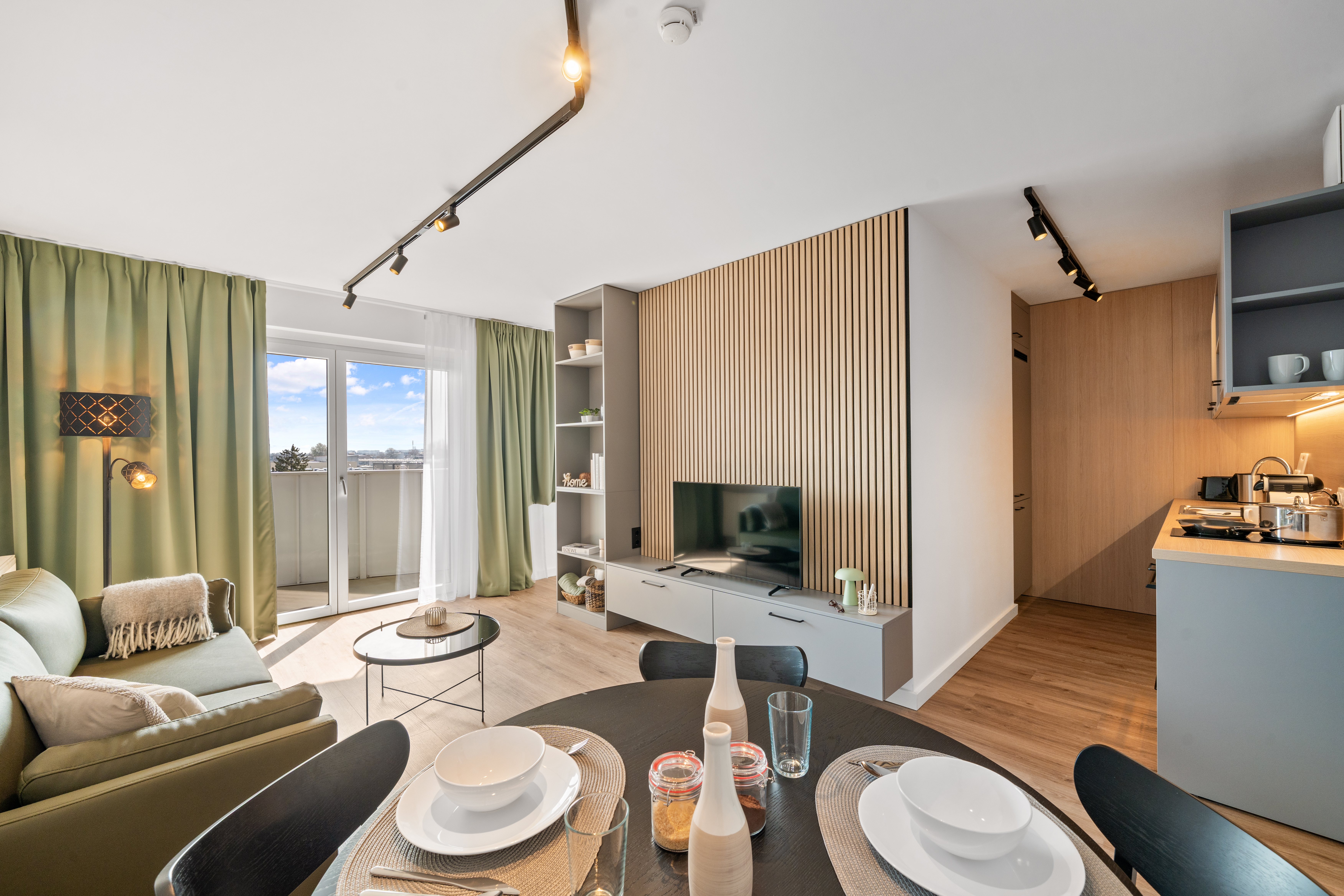 Modern apartment with a living room, open kitchen, and balcony