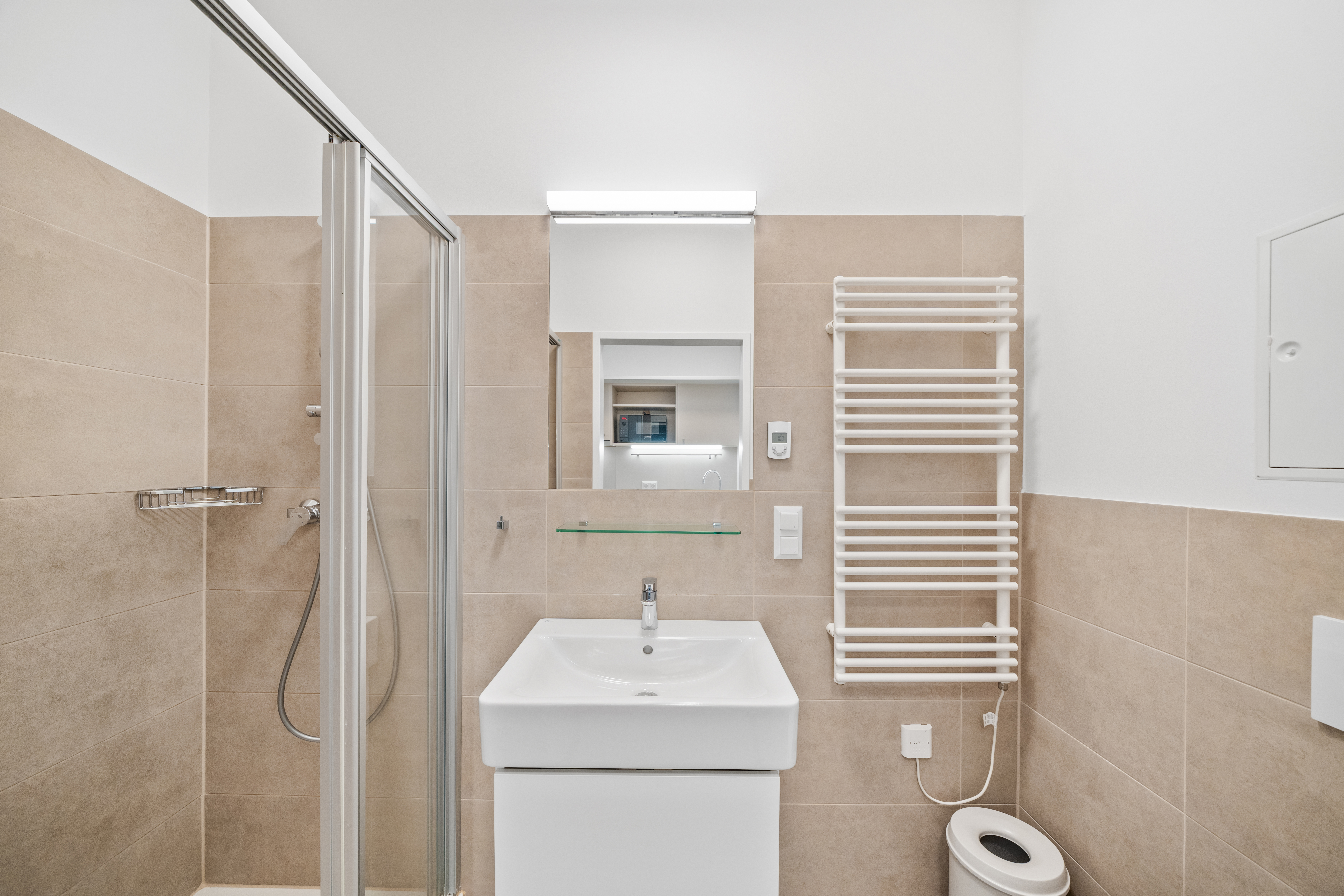 Modernes Badezimmer in einem Room4Rent Apartment mit Dusche, Waschbecken und Handtuchwärmer